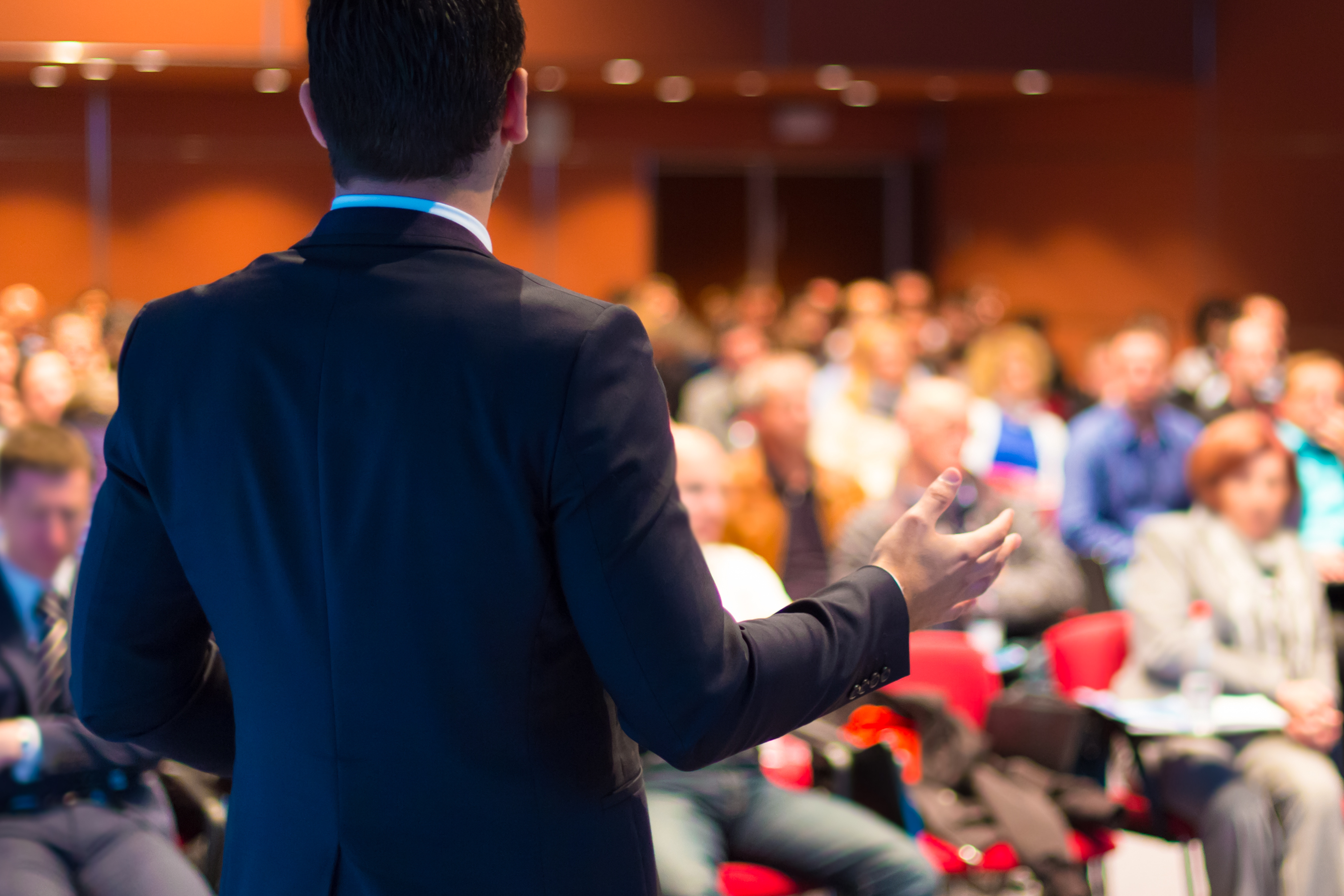 Man speaking in front of crowd