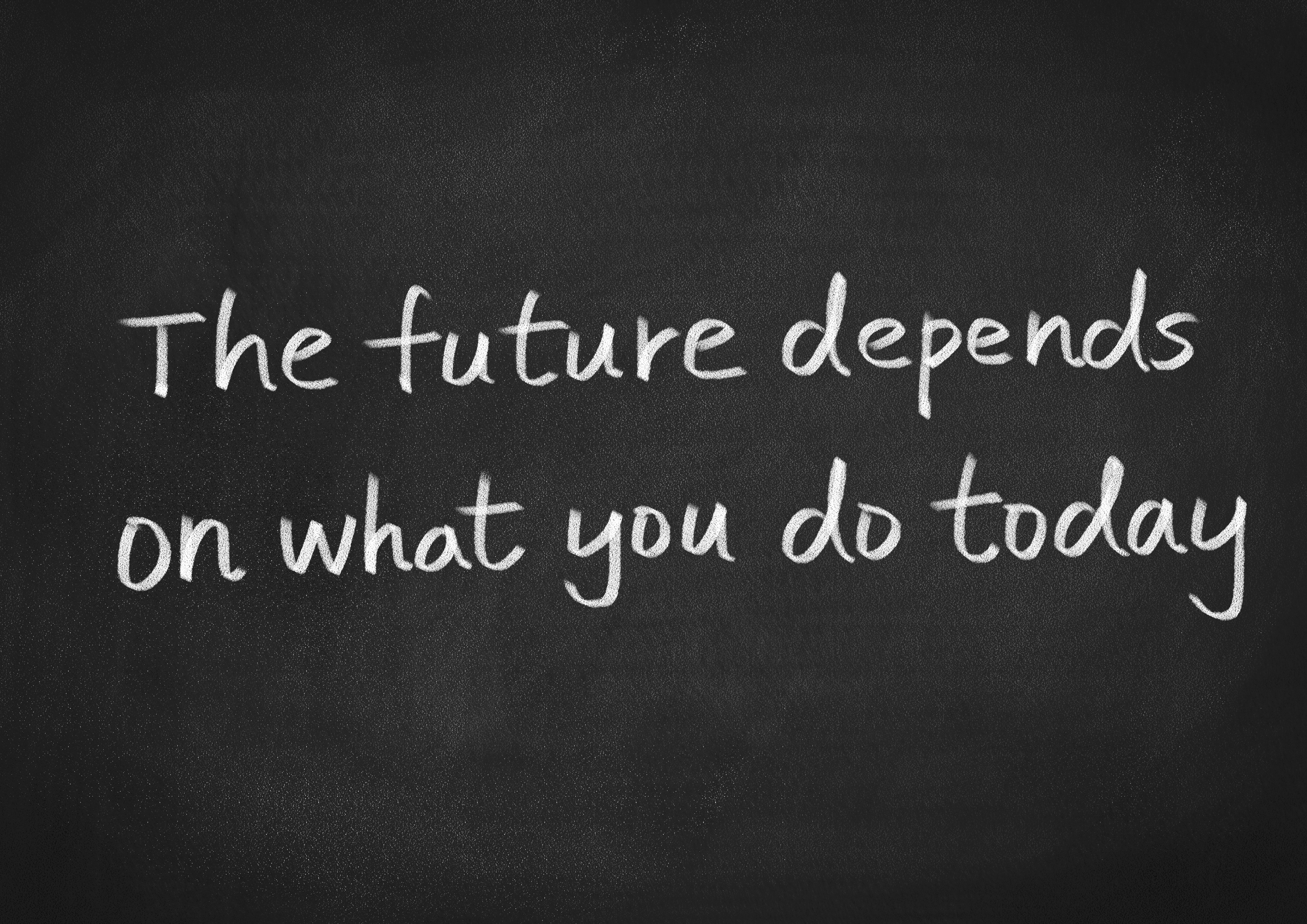 The future depends on what you do today words on a chalkboard background