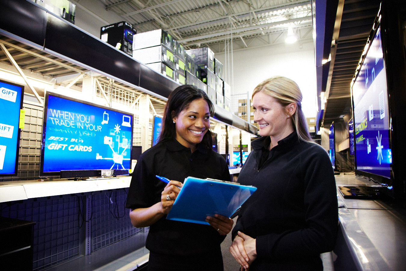 Two sales reps working in a retail store