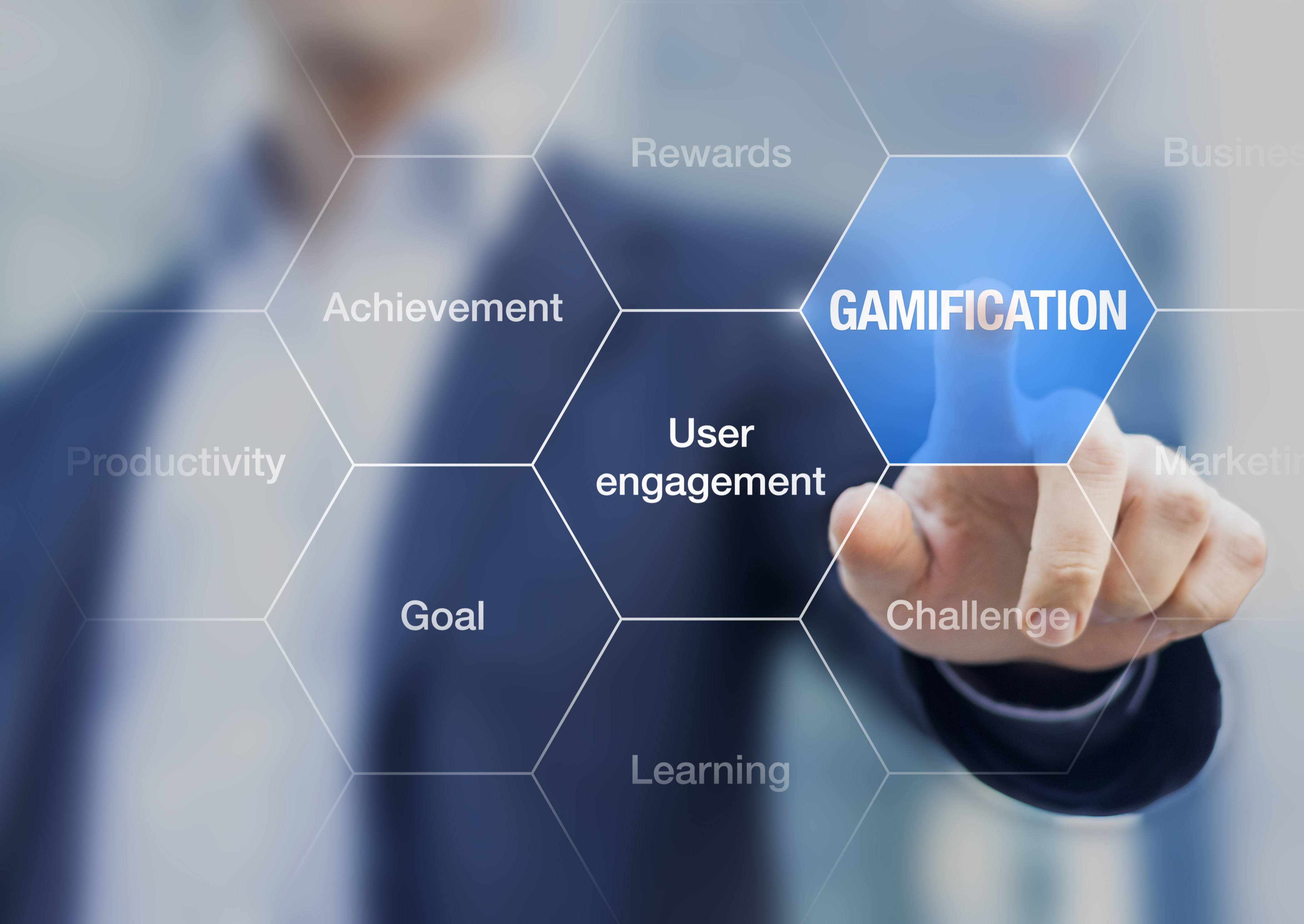Image of a business man pointing at the word Gamification, user engagement, learning, etc.