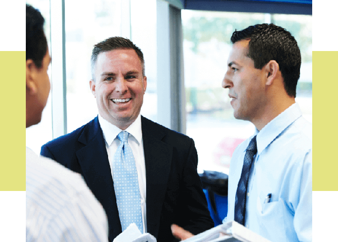Image of a sales rep meeting with two businessmen.