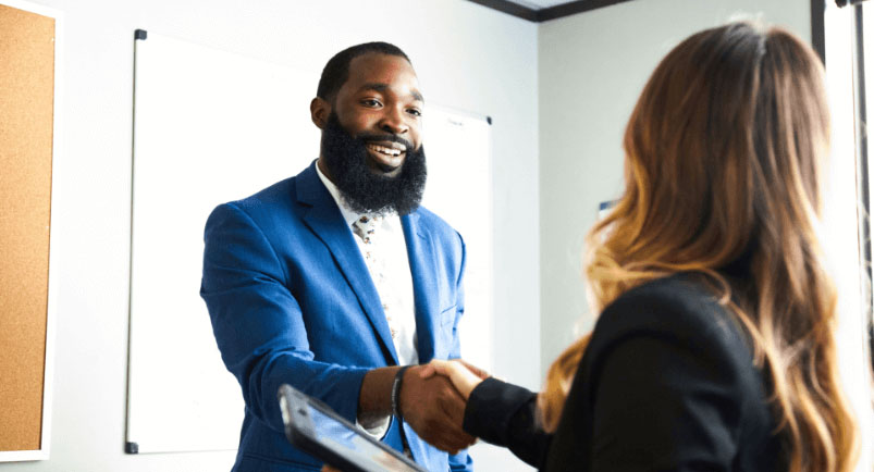 Image of a B2B sales rep shaking hands with a customer